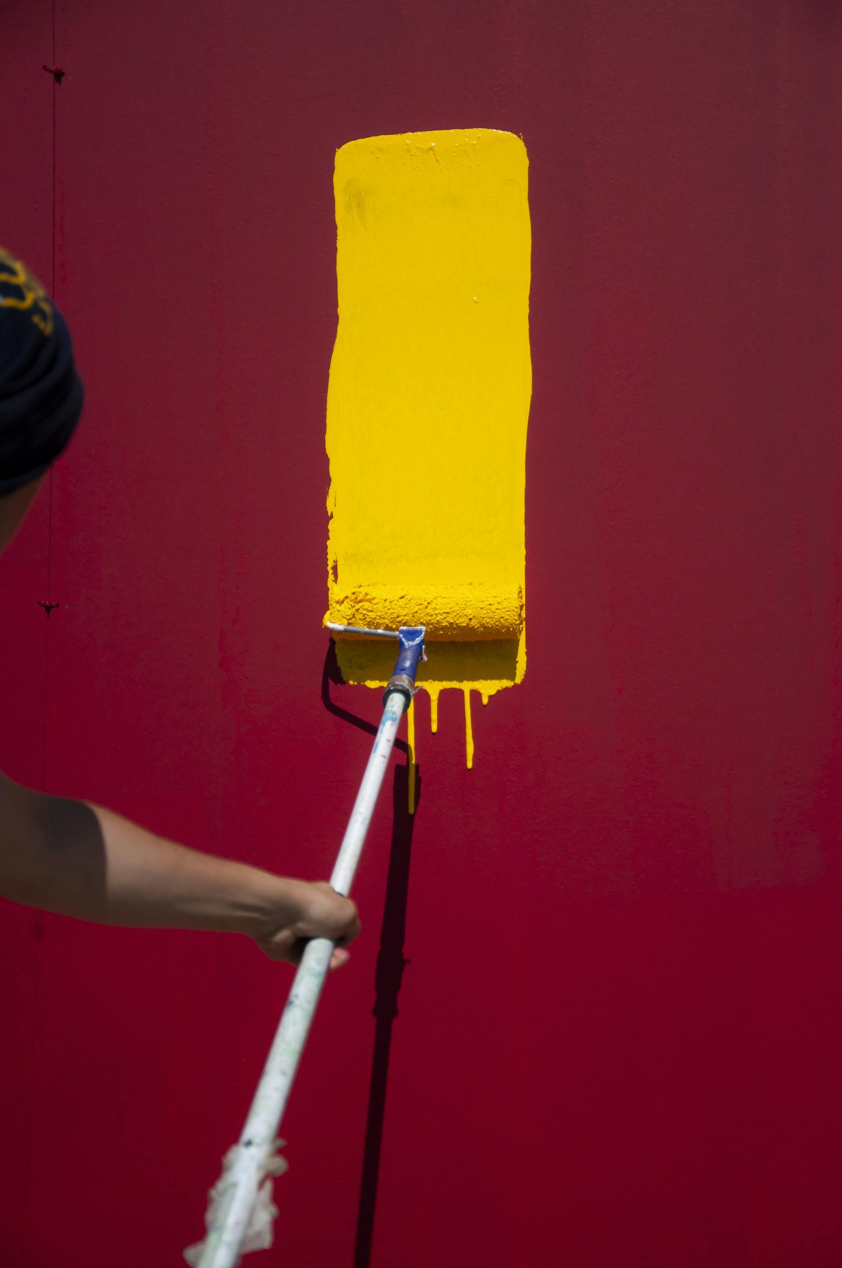 Anonymous painter with yellow roller painting